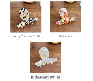 Detailed look at acetate claw clips in tortoiseshell, colorful floral, and pearl white patterns