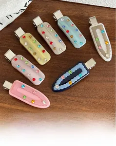 Detail view of colorful rhinestone hair clips with premium acetate finish and metal base