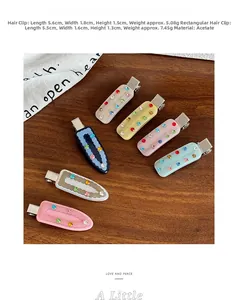 Close-up of acetic acid hair clips with colorful rhinestones on a wooden background