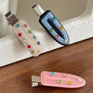 Elegant acetate hair clips with colorful rhinestones in cream, blue, and pink colors