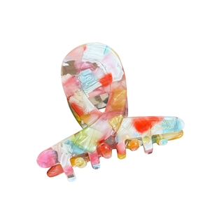 Elegant tortoiseshell acetate hair claw clip with colorful marble pattern and gold logo
