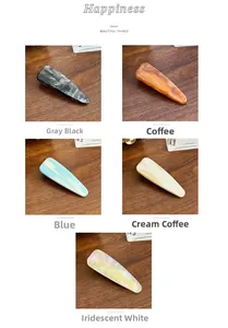 Close-up of marble texture acetate hair clips in five colors on a wooden background