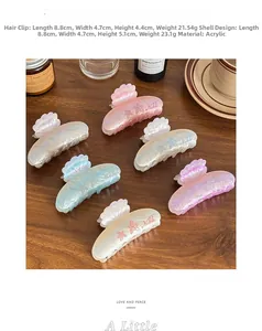 Detail showing high-quality pearlescent starfish claw clips on a wooden surface