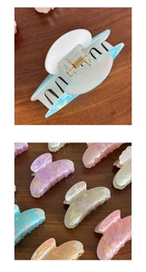 Close-up of colorful pearlescent starfish hair claws with durable metal springs