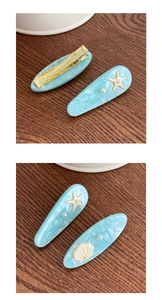 Detailed macro view of ocean-style hair clips with starfish, shell and pearl accents