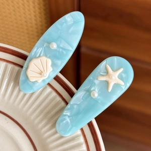 Ocean style light blue hair clips with marble texture, shell, starfish and pearls decor