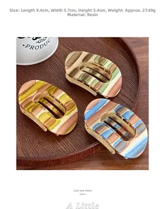 Detailed size view of resin hair claw clips measuring 9.4cm by 5.7cm in retro stripes