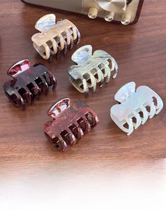 Set of large acetic acid hair clips in Morandi colors with marble textures on wood