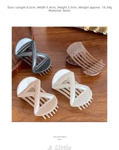 Detailed view of four resin hair clips in neutral colors on a vintage wood surface