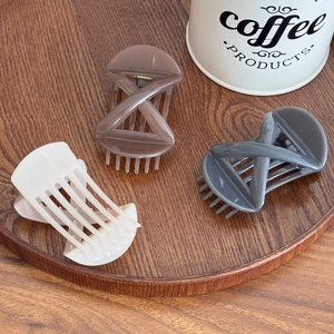 Three-piece large hair claw clips in cream, mocha, and grey with cross geometric design