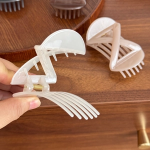 Minimalist geometric bow hair clips in creamy white and nude pink with metal springs