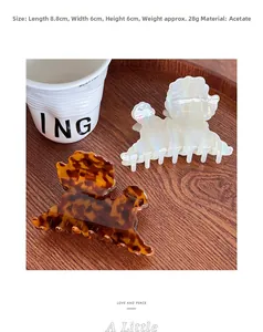 Detail view showing dimensions of brown and white acetate dog-shaped hair claw clips