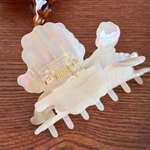 Elegant 3D shell acetate hair claw clip with pearlescent white finish and gold spring