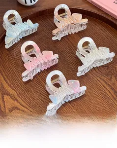 Close-up of five colorful fishbone-shaped hair claws made of acetic acid resin material
