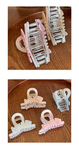 Detail showing the fishbone structure and golden spring of the iridescent hair claw clips