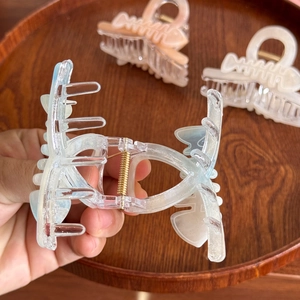 Iridescent fishbone hair claw clips in blue, pink, and white with pearlescent finish