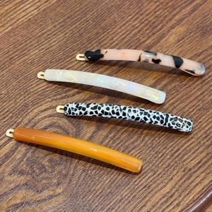 Set of four minimalist acetate hair clips in leopard, tortoiseshell, and amber patterns