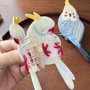 Cute bird-shaped acetate hair claw clip with pearlescent texture for elegant updos