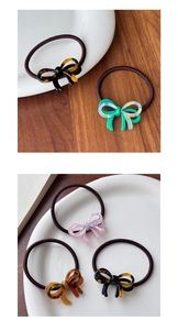 Close-up of elegant bow hair ties with marble pattern acetate and high elastic band