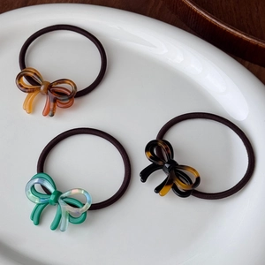 Three-piece acetate bow hair ties set with amber and tortoiseshell patterns for ponytails