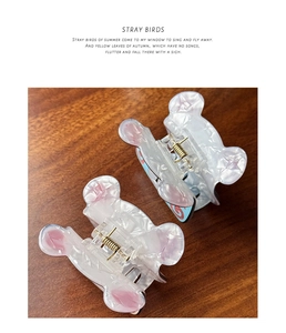 Detail of cute bear-shaped hair claws made of acetate with elegant marble texture