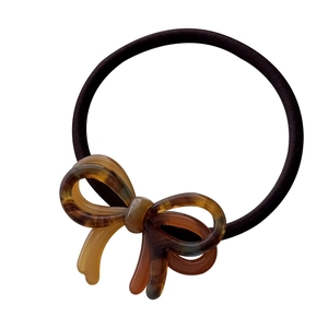 Elegant bow hair tie featuring a tortoiseshell pattern acetate accent and elastic band