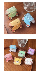 Detailed macro view of colorful bear claw clips in pink blue and yellow pastel tones