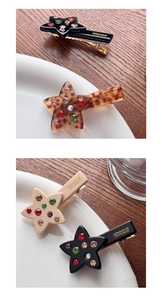 Close-up of star-shaped hair clips with colorful rhinestones in multiple colors