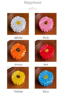 Detailed grid showing 6 colors of acetate daisy flower hair claws on wood background