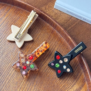Star shaped acetate hair clips with colorful crystals in minimalist and tortoiseshell style