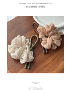 Detail view of large organza hair scrunchies with leather accents, size 17.5cm by 13cm