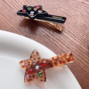 Star shaped acetate hair clips with colorful rhinestones in black and leopard patterns
