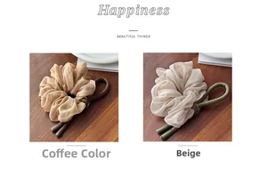 Detail of coffee and beige organza scrunchies with long bow ribbons on wooden background