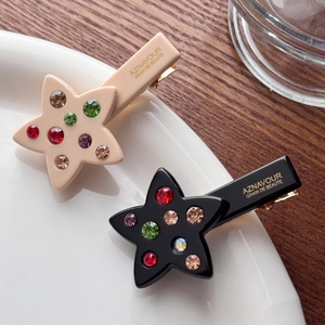 Star-shaped acetate hair clips with colorful rhinestones in pink and black colors