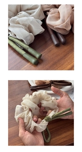 Detailed macro view of soft chiffon scrunchies with long ribbons in multiple earthy tones