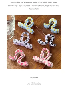Close-up of pastel hair claws with cute paw prints in a wooden tray detail view