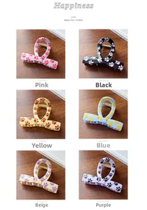 Detailed grid showing six assorted colors of cat paw print hair claw clips on wood