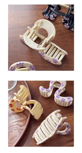 Detailed macro view of matte plastic hair claw clips with cute colorful cat paw prints