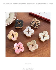 Detailed view of assorted acetate flower hair claws with metal base on wooden background
