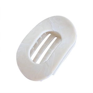Flat oval ink-patterned hair claw clip with cream marble texture for elegant styling