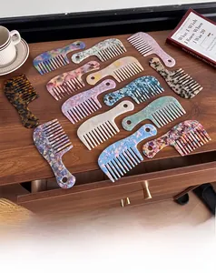 Macro detail of tortoiseshell acetate wide-tooth combs on a cozy wooden drawer surface