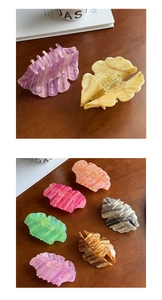 Detailed macro view of colorful acetate hair claw clips with elegant marble patterns