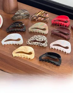 Detail of diverse oversized acetate hair claws in tortoise and marble textures