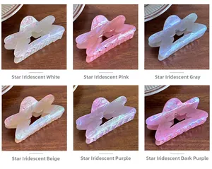 Detailed grid of star-shaped hair claws in six shimmering colors on a wooden surface