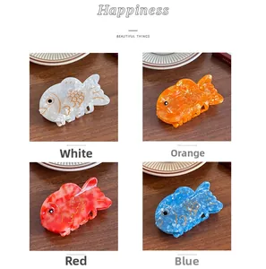 Detailed four-color collage of koi fish acetate hair claws in white, orange, red, and blue