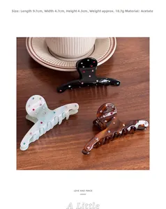 Detailed view of acetic acid hair claw clips in various colors with rhinestone accents