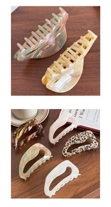 Close-up of large acetate hair claw clips in tortoiseshell and pearl patterns