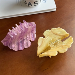 Large acetate shell hair claws in purple and yellow with elegant marble texture pattern