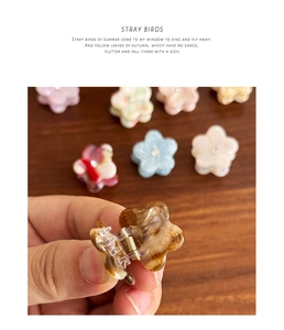 Macro detail of acetate flower hair clips with marble texture and metal spring mechanism