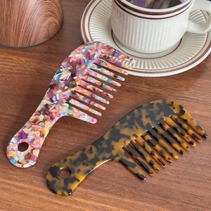 Elegant cellulose acetate wide-tooth combs in floral and tortoiseshell patterns